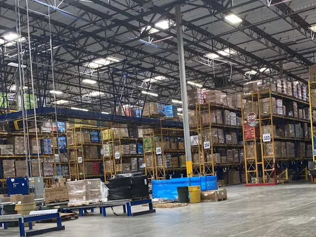 LED high-bay fixtures above racking in a Lowe's distribution center warehouse