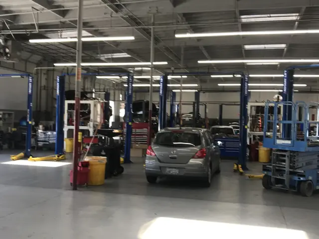 Bright LED lighting over the vehicle lifts in the Mossy Nissan El Cajon service department