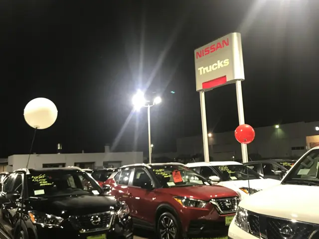 LED pole lighting over the vehicle display lot at Mossy Nissan in Kearny Mesa at night